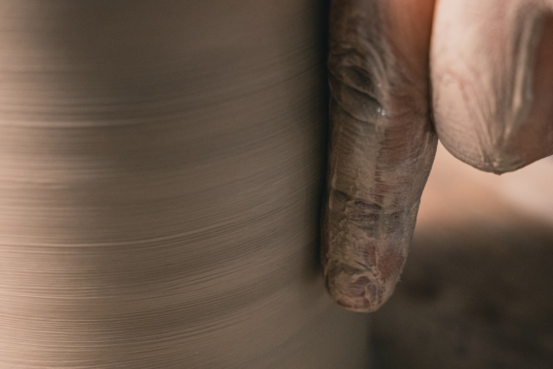 Clay being wedged by hand, showing the spiral pattern and texture
